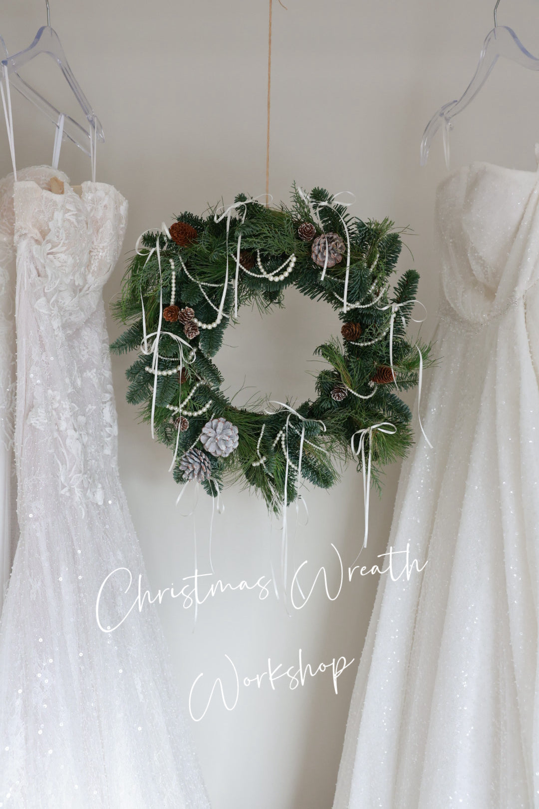 Christmas wreath hanging between two white dresses with text 'Christmas Wreath Workshop'.