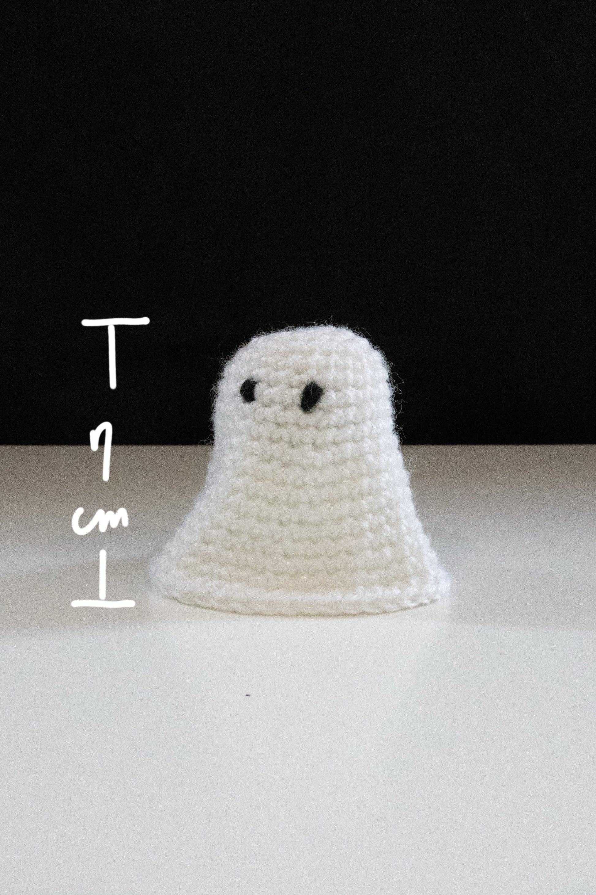 Crocheted little ghost measuring 7 cm tall, perfect for Halloween decorations and crafting.