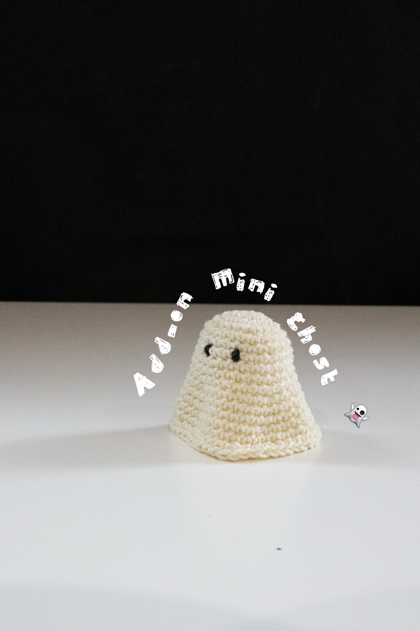 Crochet mini ghost plush with black eyes on a white table, perfect for Halloween decor.