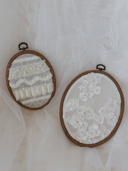 Two embroidered hoop art pieces on a white fabric background