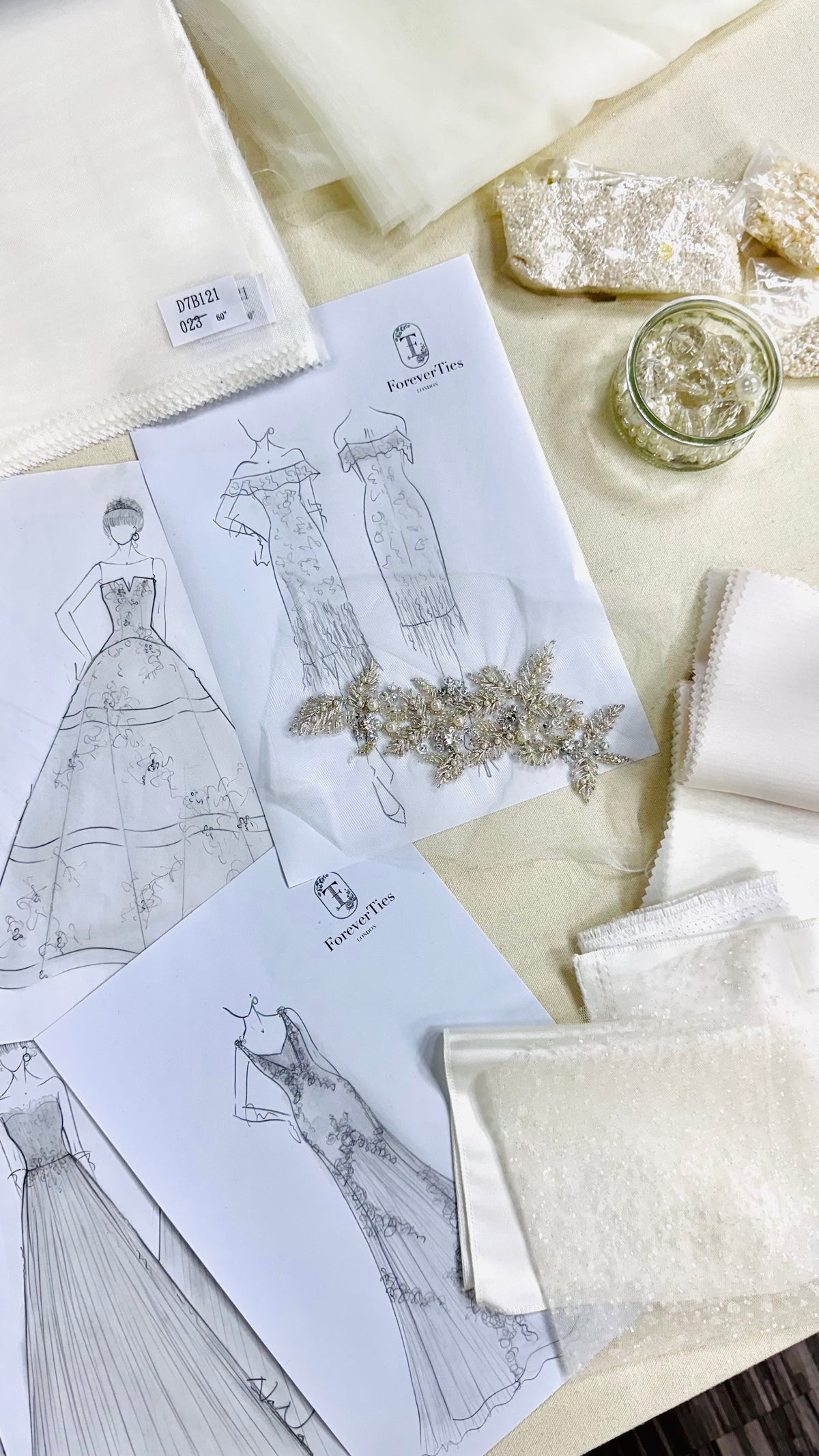 Bride attending her first bespoke wedding dress consultation at the ForeverTies atelier, reviewing gown sketches and fabric swatches with her personal dressmaker.